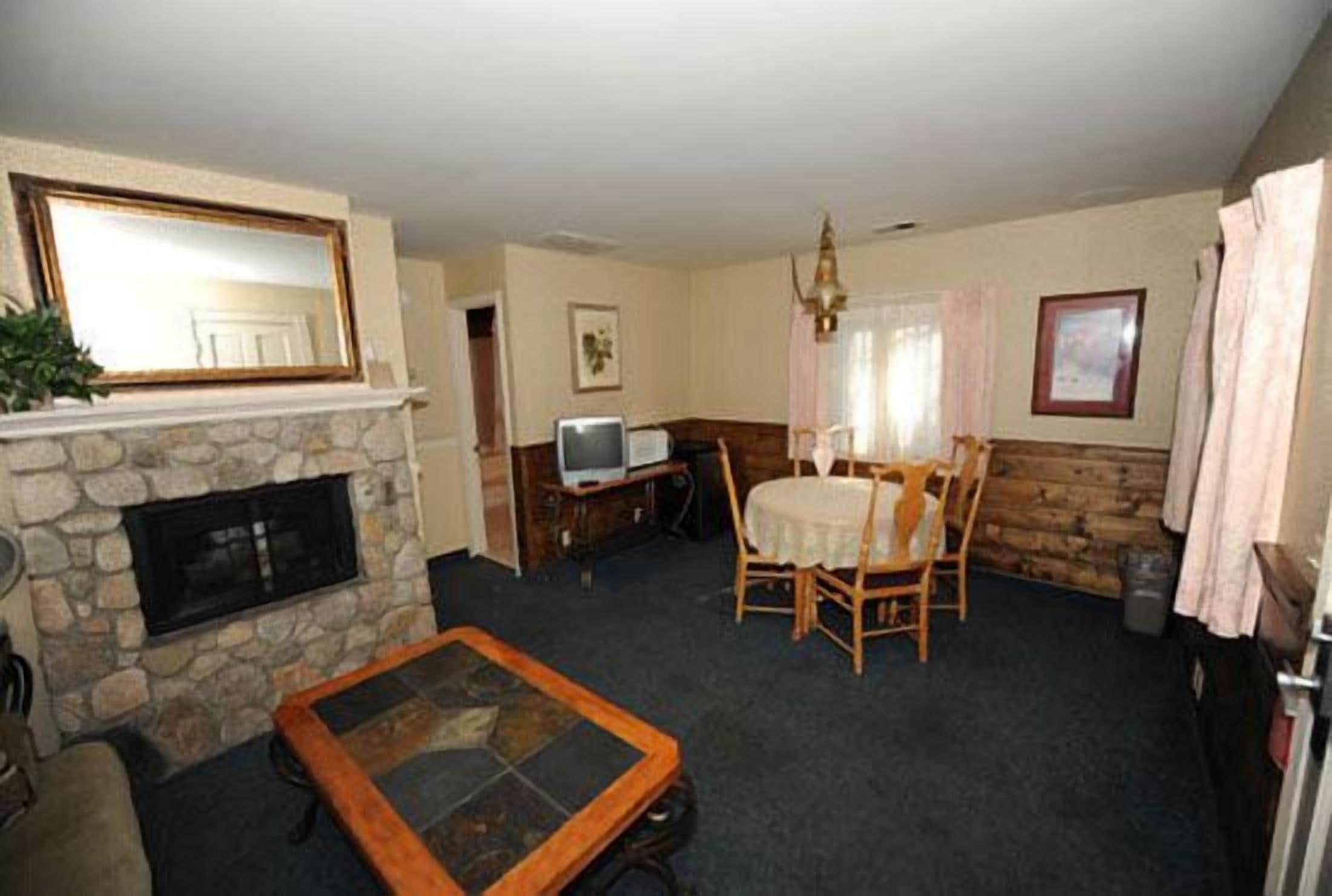 suite, 1 king bed ( with either sofa sleeper or 2 twin rollaways) ac in bedroom only | living area | 22-inch tv with cable channels