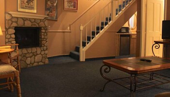 Suite, 1 King Bed ( with either Sofa Sleeper or 2 Twin Rollaways) AC in Bedroom only | Living area | 22-inch TV with cable channels