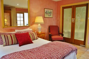 Relax in comfort with a large bed, nightstand, and stylish chair.