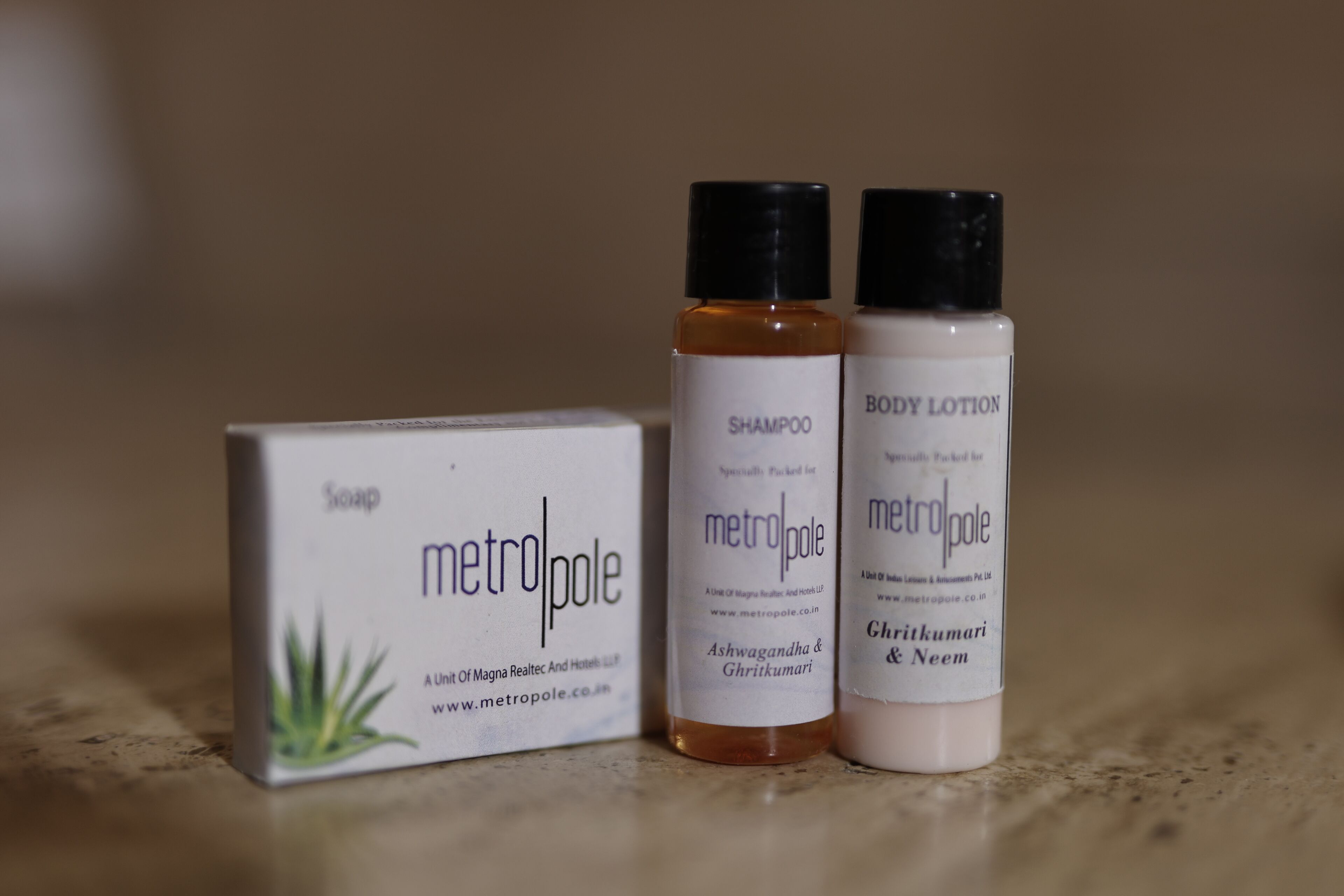 A box of soap and two bottles of body lotion.