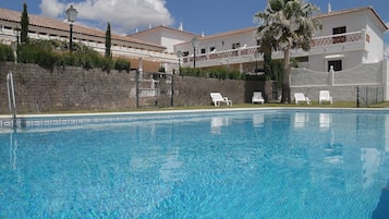 Piscine extérieure, parasols de plage, chaises longues