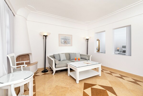 A modern living room with a sofa, coffee table, and floor lamp.