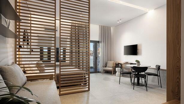 Una sala de estar moderna con un sofá, una zona de comedor con sillas y una mesa, un televisor montado en la pared y un separador de madera.