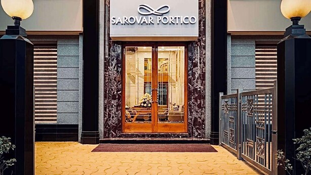 The entrance of Sarovar Portico with a marble facade and a glass door entrance. - Sarovar Portico Kalupur Ahmedabad (Ahmedabad)