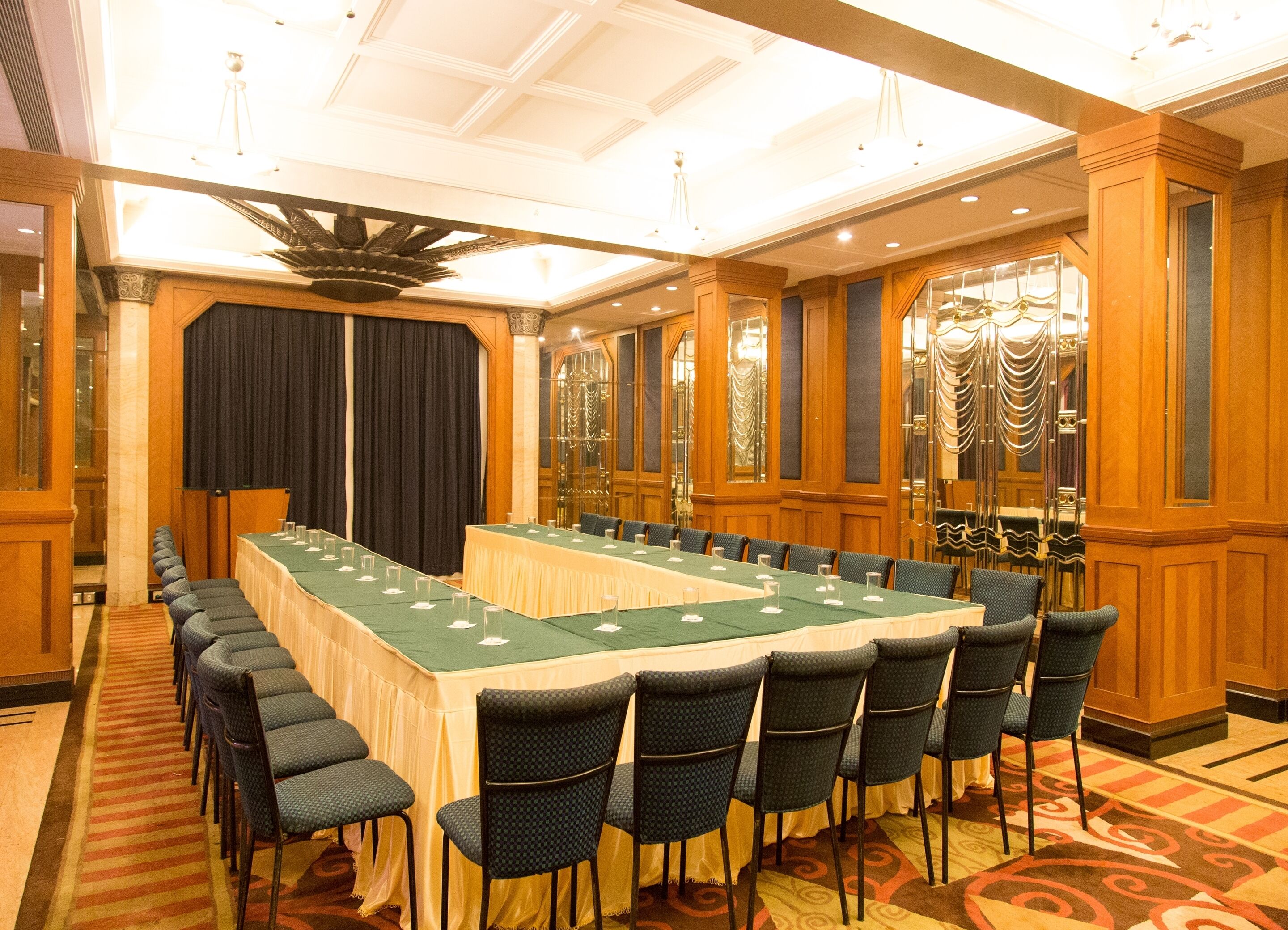 A conference room with a long table, chairs, and a chandelier.