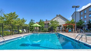 A rectangular swimming pool with clear blue water, surrounded by a tiled deck. - Homewood Suites by Hilton Leesburg (Leesburg)