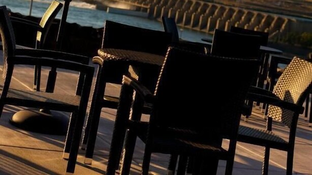 Outdoor seating with a view of a dam and hills. - Celilo Inn (The Dalles)