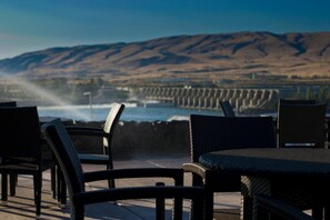 Outdoor seating with a view of a coastal landscape and a dam.