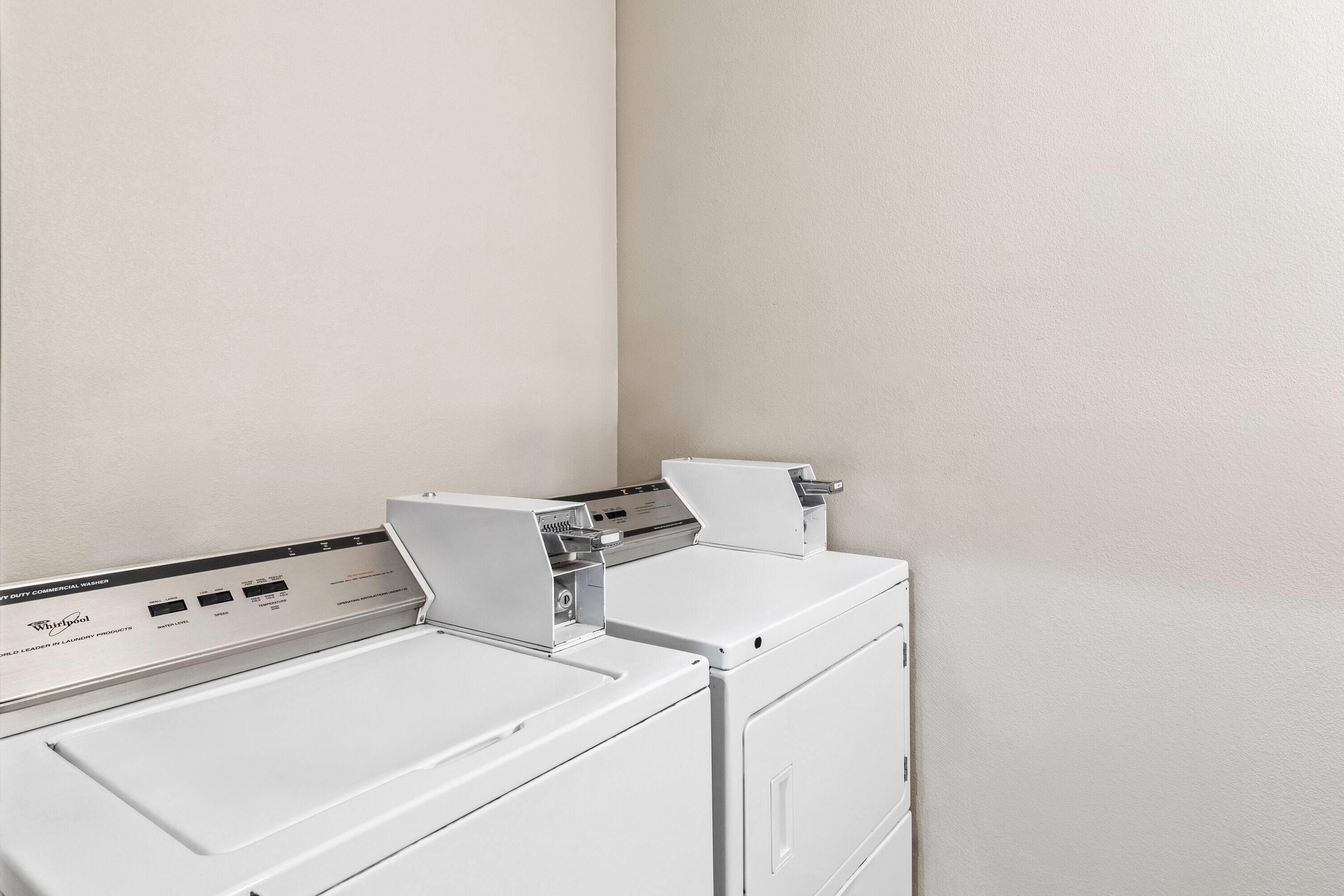 A front view of a Whirlpool washer and dryer unit in a laundry room.