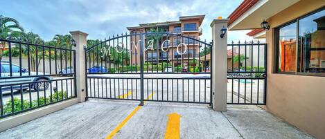 A gated entrance to a building with a clear pathway marked by arrows.