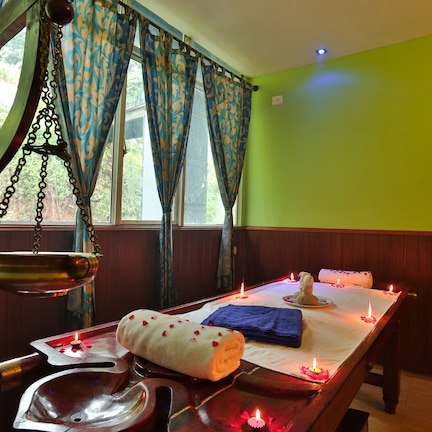 A room with a wooden table set for a meal, a hanging scale, and a window with patterned curtains.