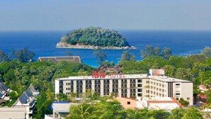 A hotel with a view of the ocean and a small island.