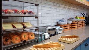 A bakery display with various baked goods and a toaster.