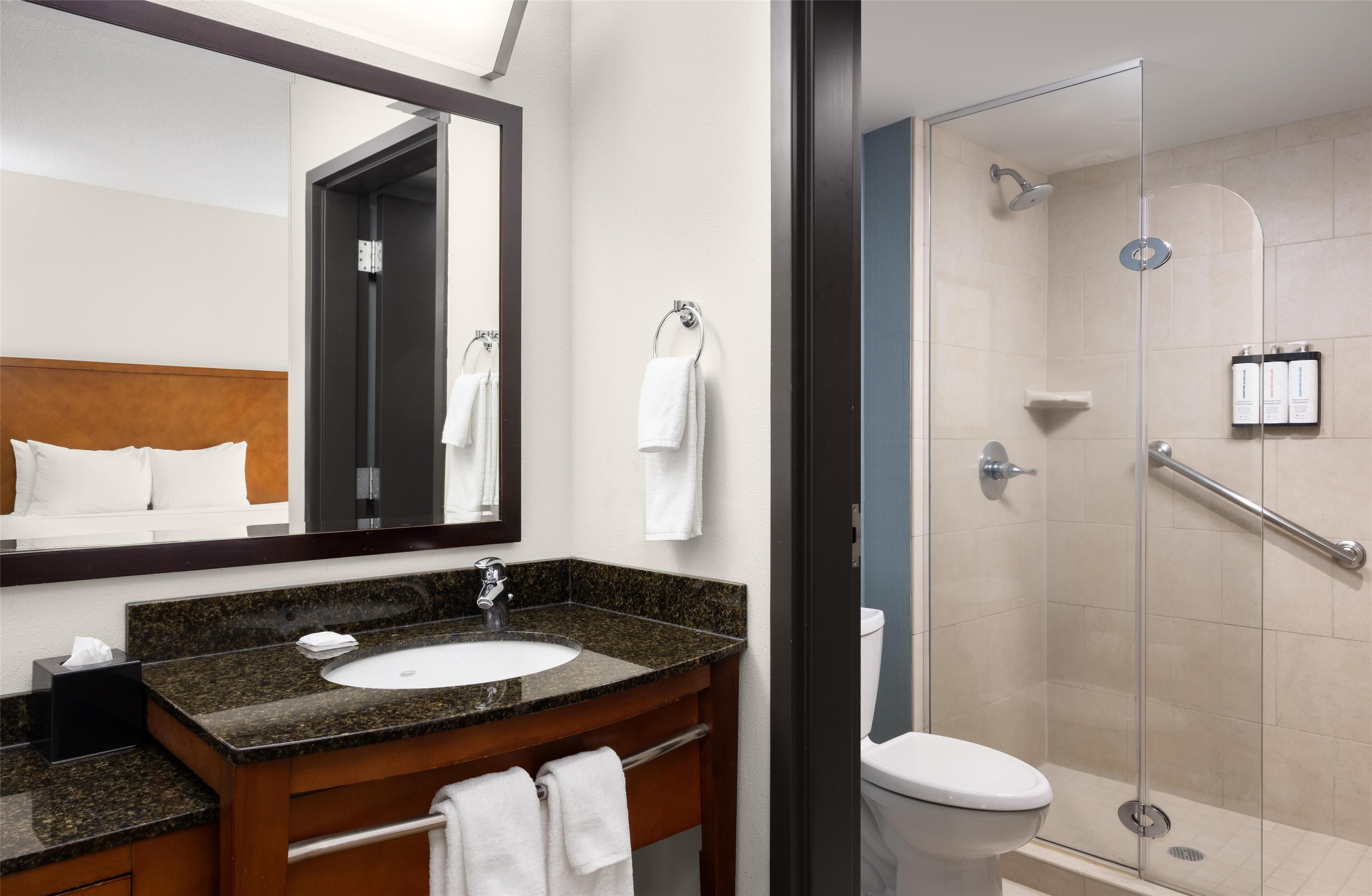 designer toiletries, hair dryer, towels