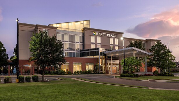 A modern hotel with a prominent entrance, a covered walkway, and a well-maintained lawn. - Hyatt Place Memphis/Germantown (Memphis)