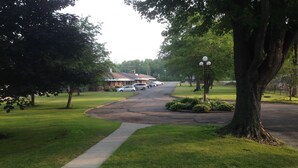A residential street with houses, a sidewalk, and a tree-lined road. - Anchor Motel (Niagara Falls)