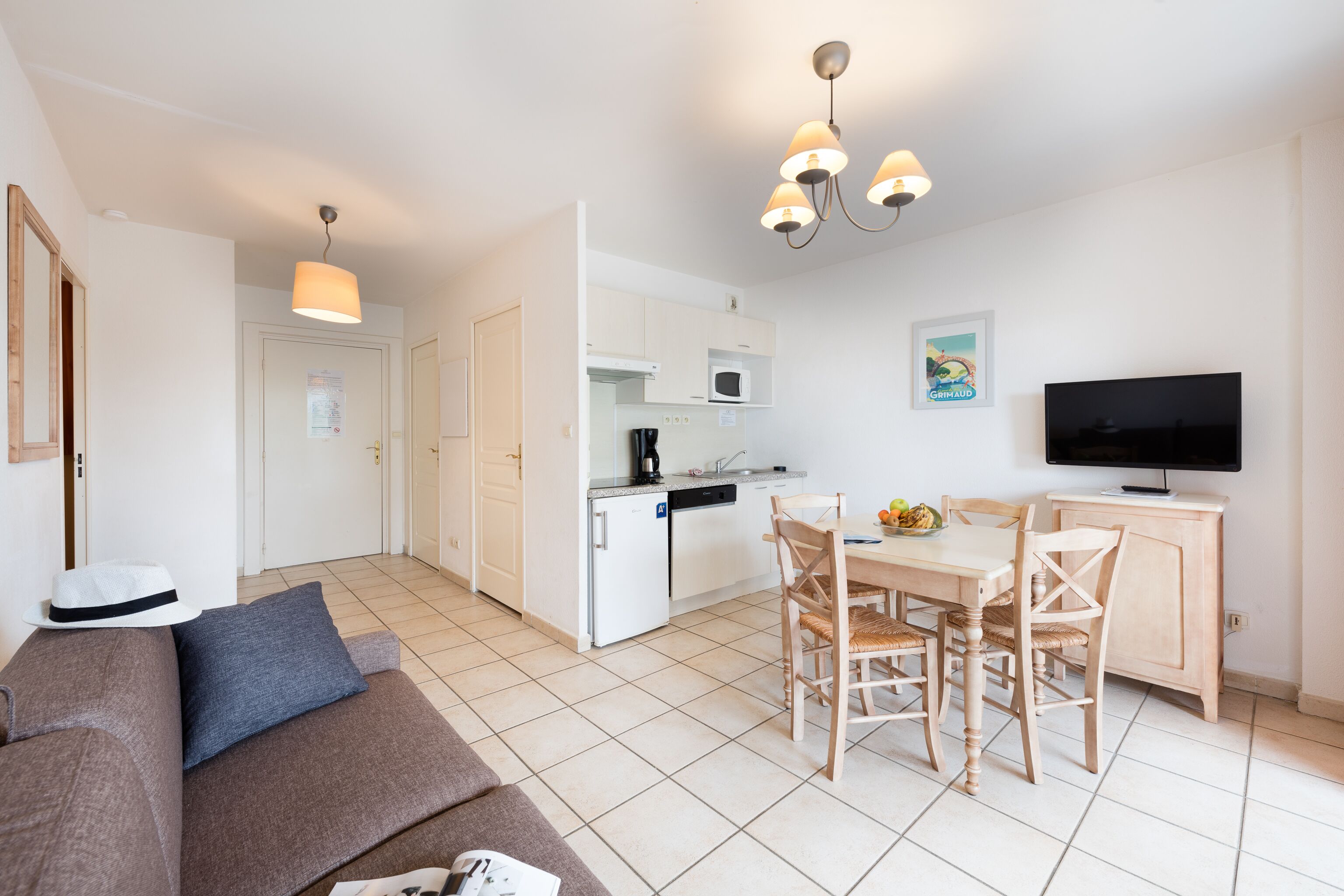 A modern apartment with a kitchen, dining area, and living room.