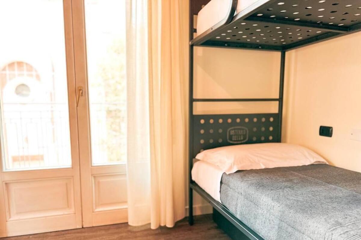A bunk bed with a metal frame and a headboard with a circular pattern.