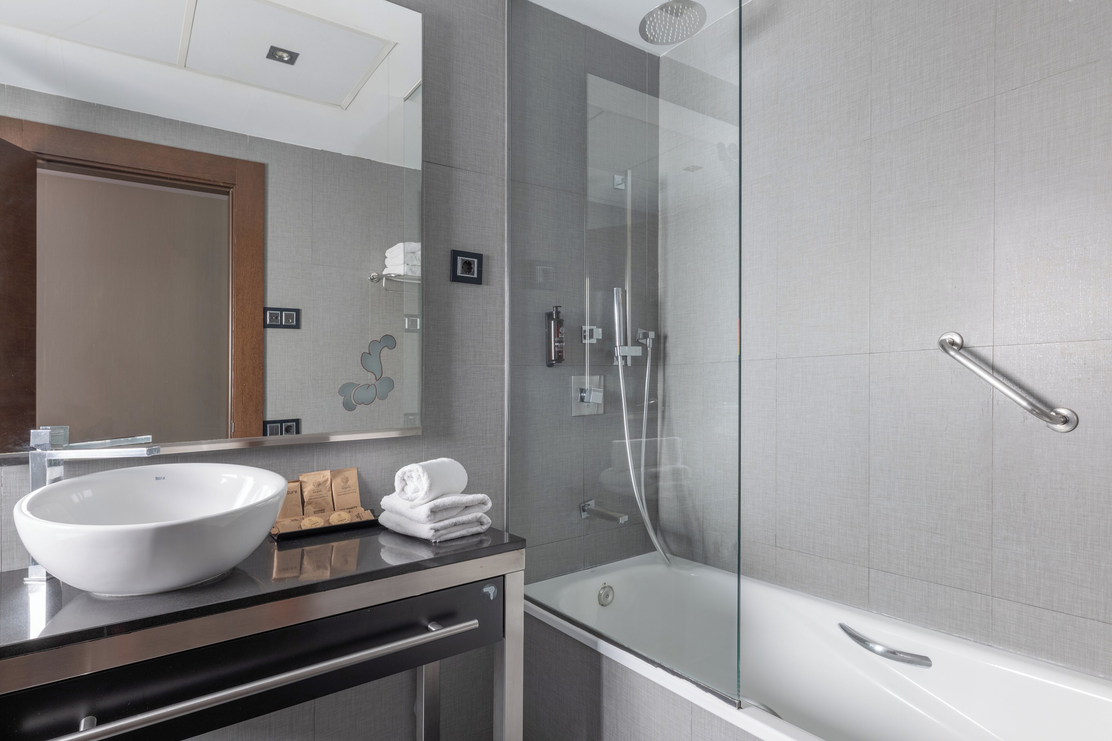 rainfall showerhead, eco-friendly toiletries, hair dryer, towels