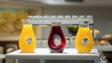 Three glass bottles with a unique design, placed on a white surface.