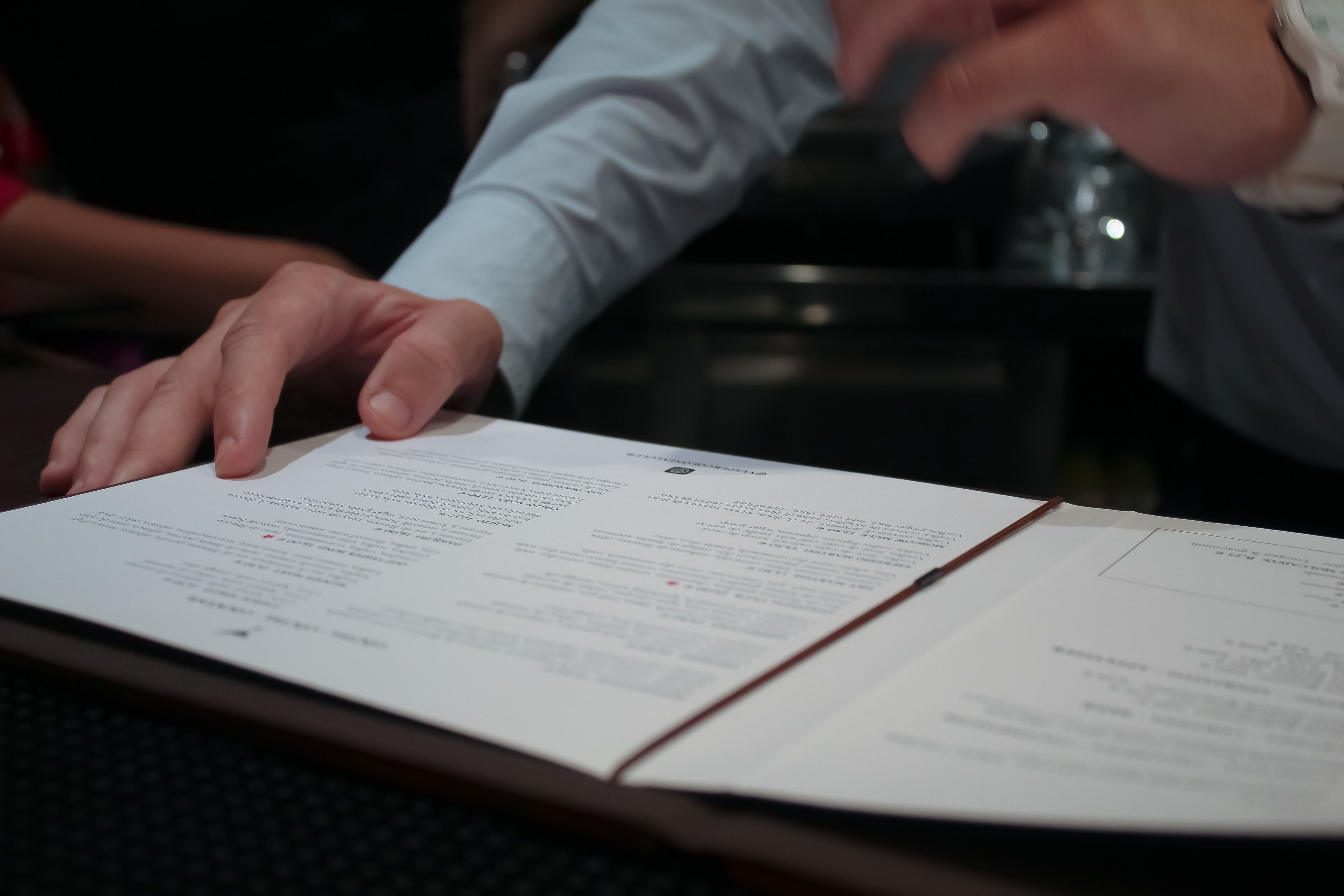 A person reading a document on a table.