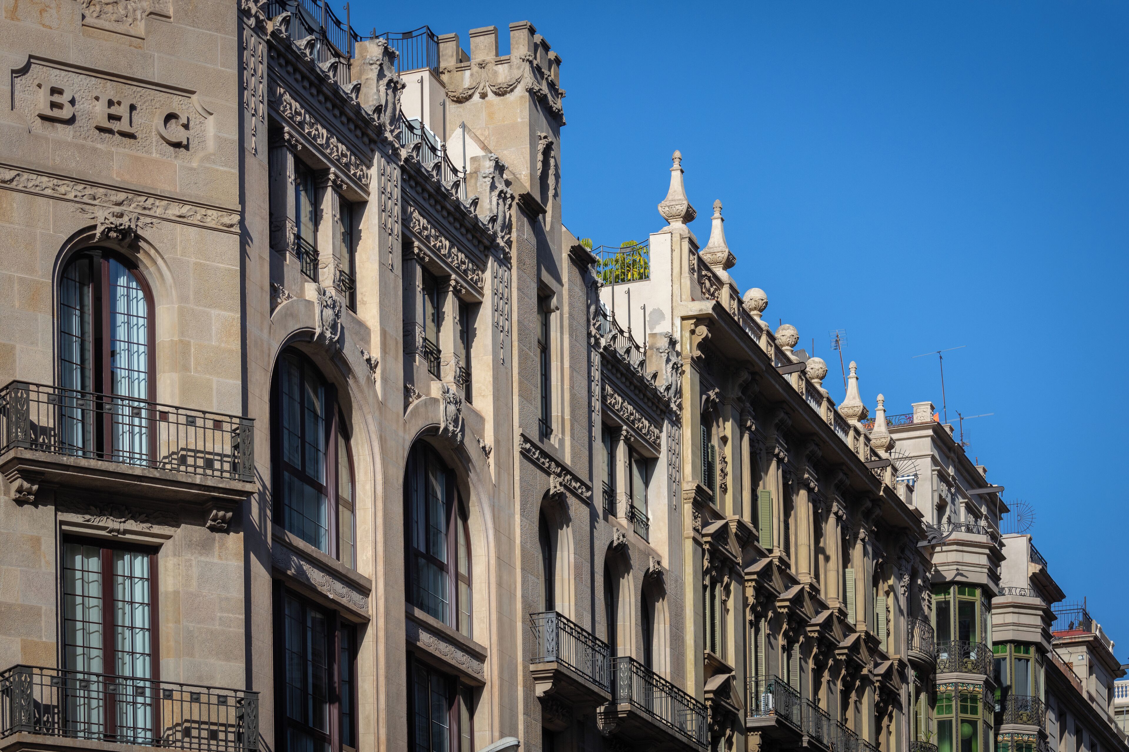 A historic building with ornate architectural details, including arched windows and decorative balconies.