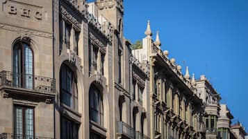 A historic building with ornate architectural details, including arched windows and decorative balconies.
