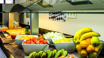 A buffet with various fruits and vegetables.