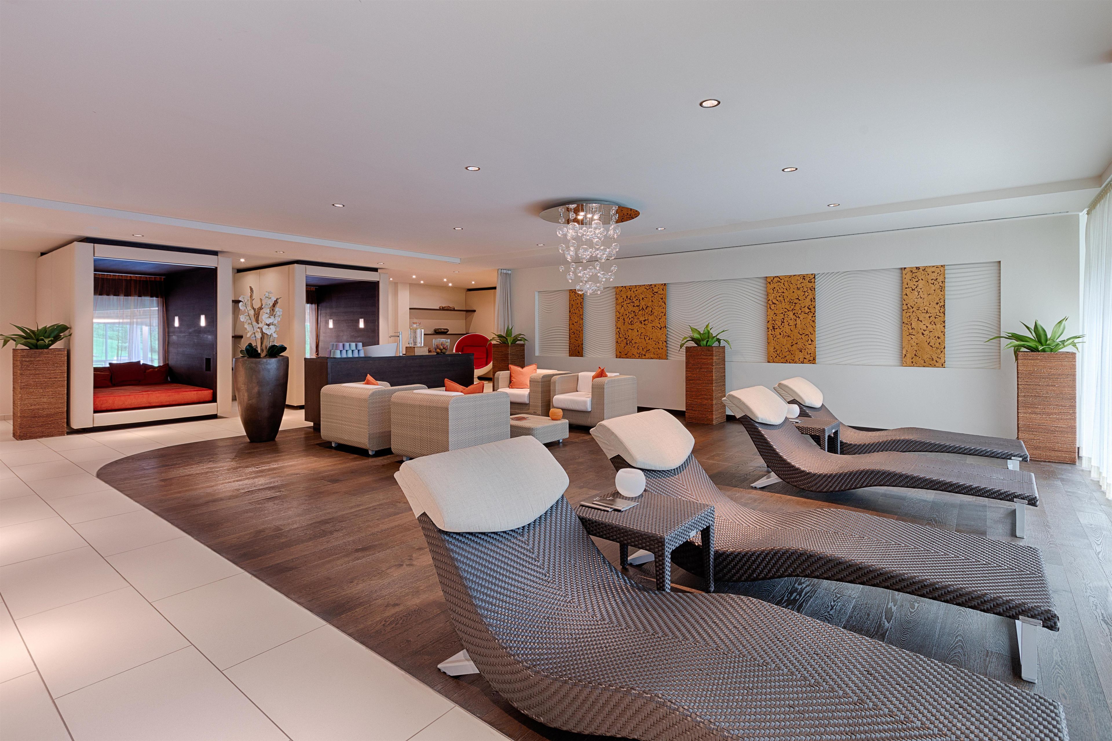 A modern lounge area with seating and a reception desk.