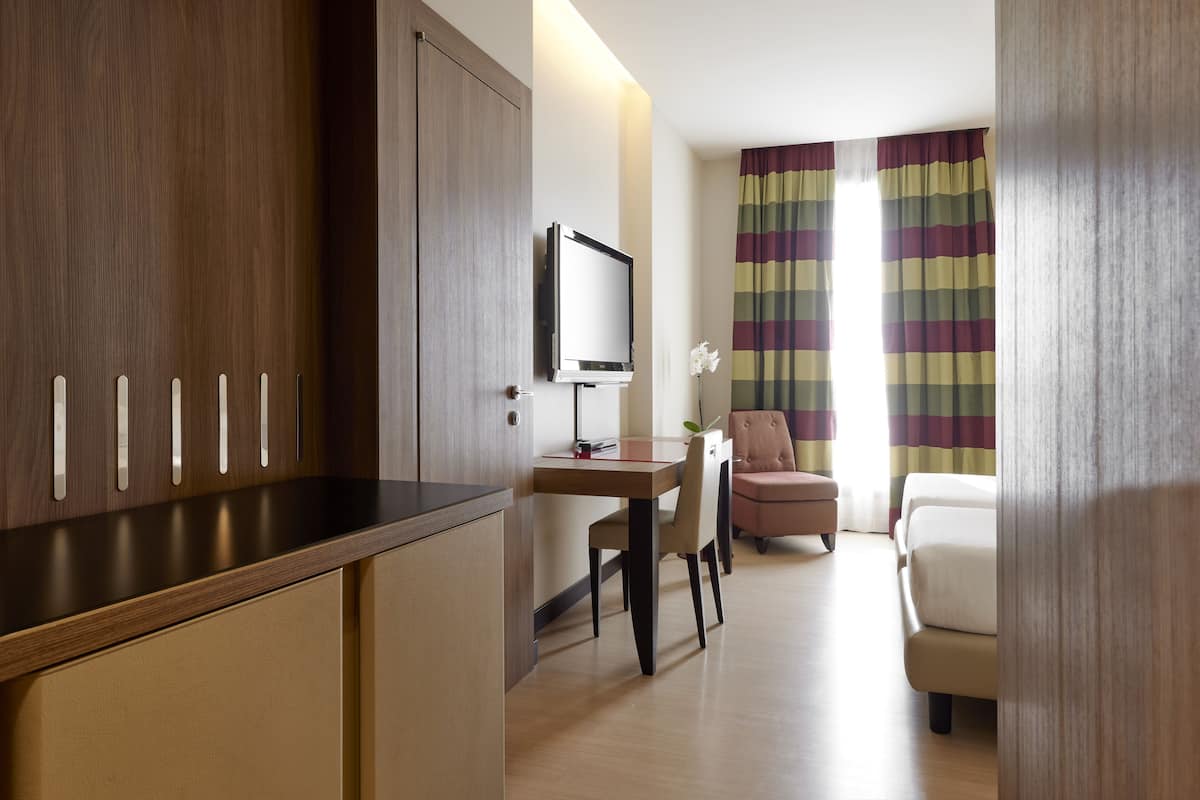 twin room | minibar, in-room safe, desk, blackout curtains