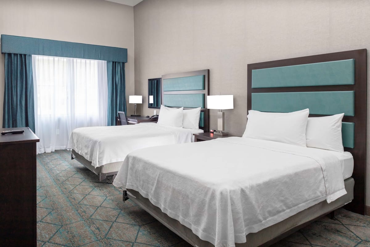 Hypo-allergenic bedding, desk, laptop workspace, blackout drapes