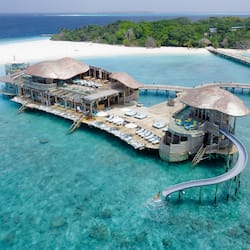Experience serene ocean views from rooms and suites with access to turquoise waters.