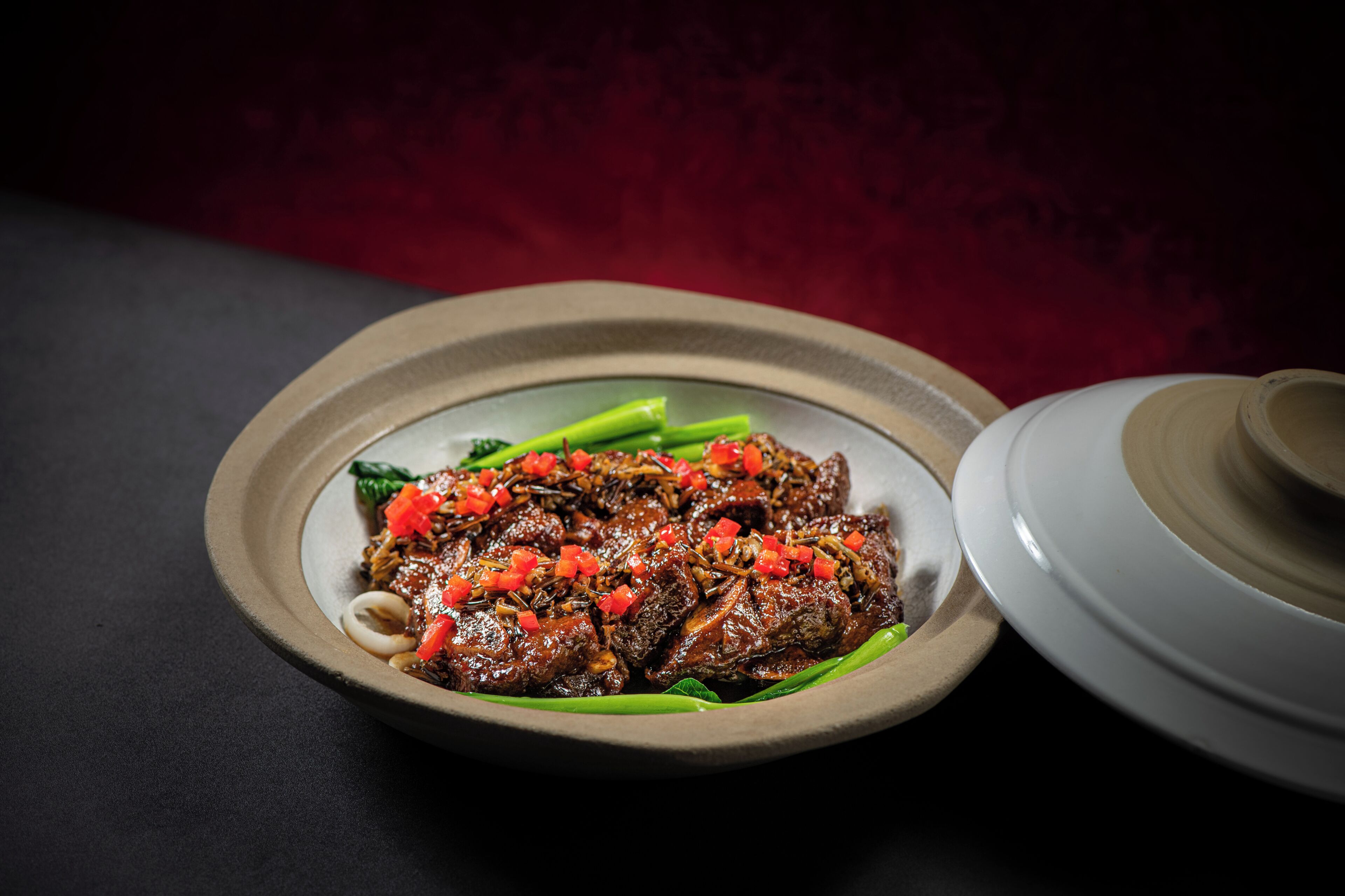 A plate of food with a bowl and a pot in the background.