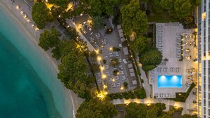 An aerial view of a resort with a pool, beachside seating, and a parking area. - Maestral Adults Exclusive Hotel (Brela)