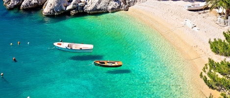 On the beach, sun-loungers, beach umbrellas