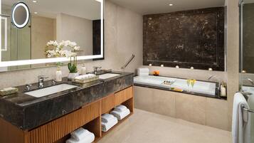 A modern bathroom with two sinks, a large mirror, and a marble backsplash.