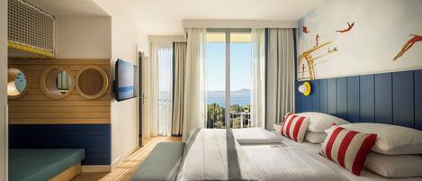 A hotel room with a bed, a bench, a TV, a window with curtains, and a mural on the wall.