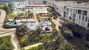 A resort with multiple swimming pools, a children's play area, and lush landscaping. - Falkensteiner Family Hotel Diadora (Zadar)