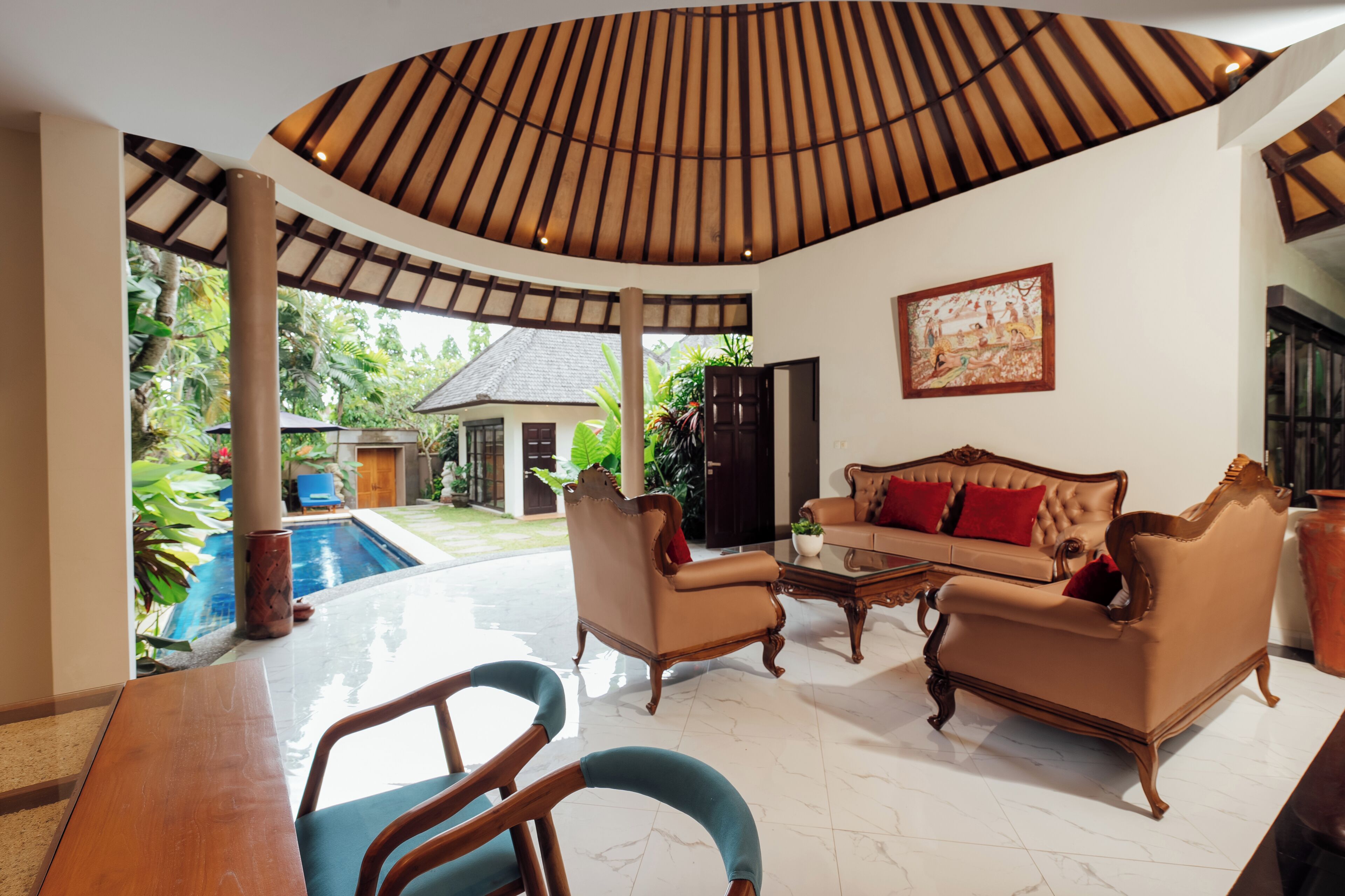 A spacious living area with a pool, a wooden ceiling, and a comfortable sofa.