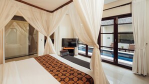 A bedroom with a large bed, a TV, and a balcony with a pool. - The Bidadari Villas & Spa Umalas, between Seminyak and Canggu (Kerobokan)