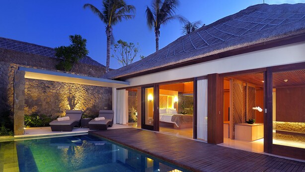 A modern resort with a swimming pool, lounge area, and a bedroom with a view. - THE HAVEN Bali Seminyak (Seminyak)