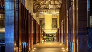 A corridor with a wooden slatted ceiling and a central walkway. - THE HAVEN Bali Seminyak (Seminyak)