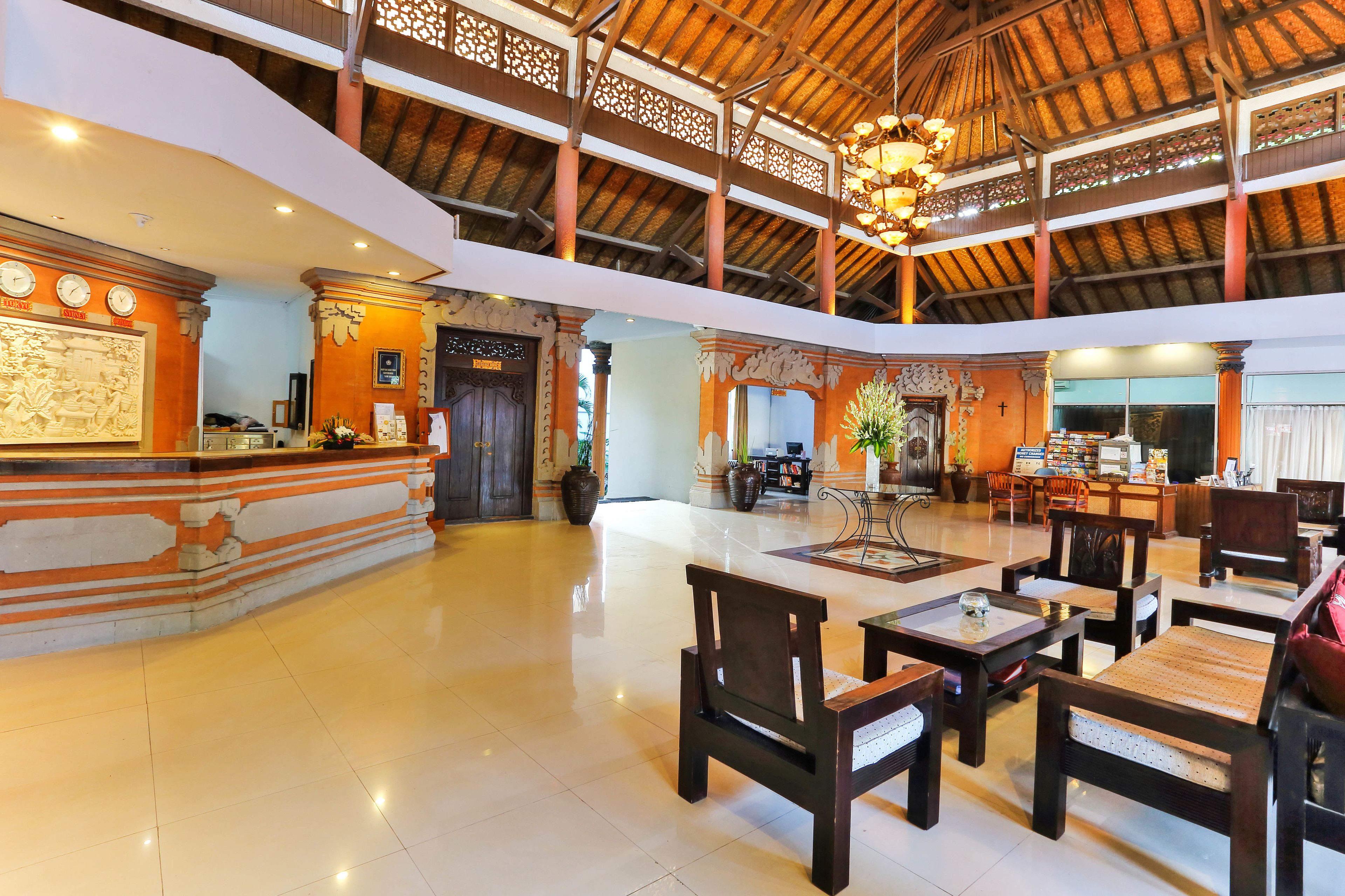 A spacious lobby with a high ceiling, wooden beams, and a reception desk.