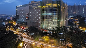 A modern building with a glass facade, labeled "ARYADUTA," and a prominent "27" sign. - Aryaduta Medan (Medan)
