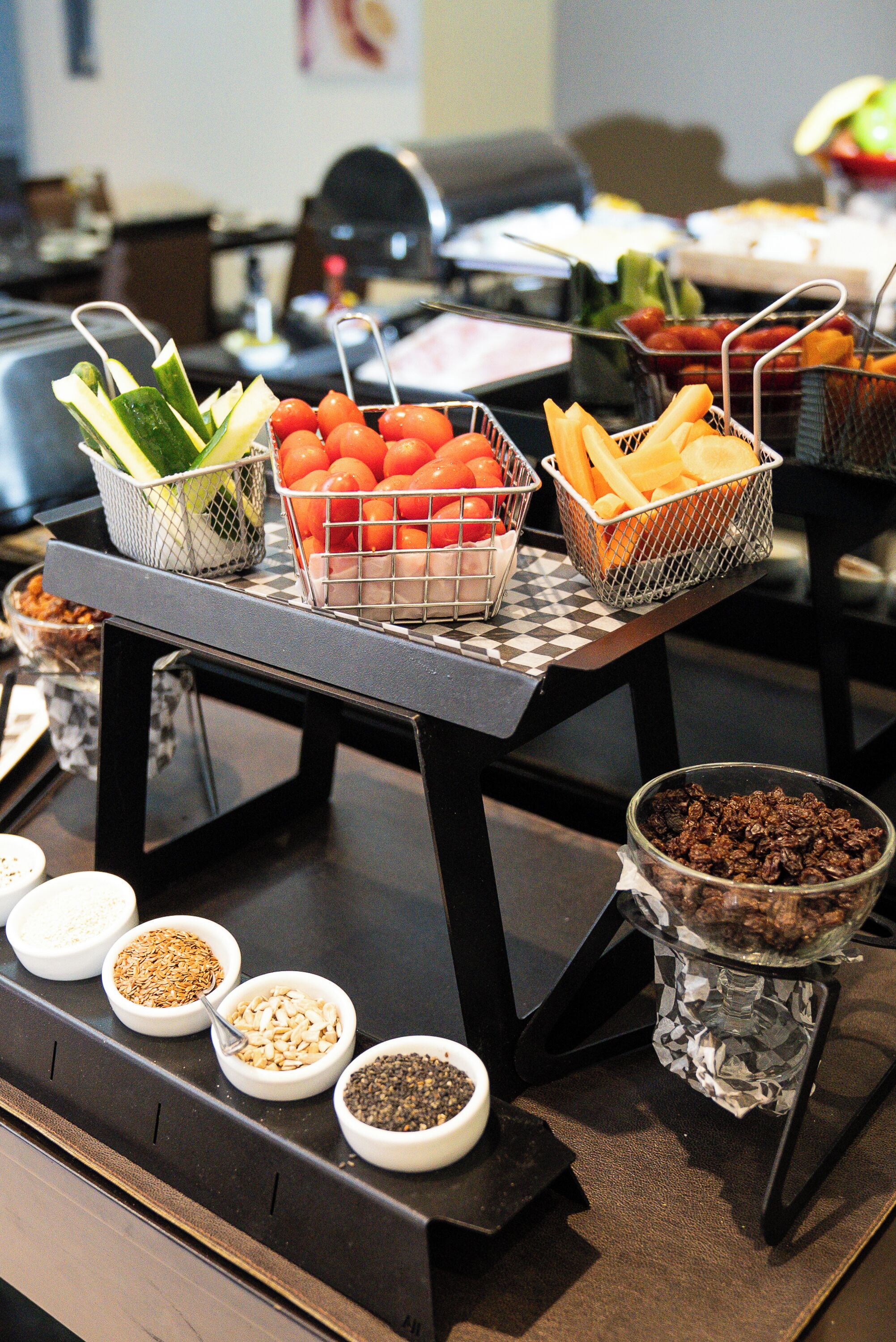 A buffet table with various food items and condiments.