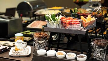 A buffet with various food items and condiments.