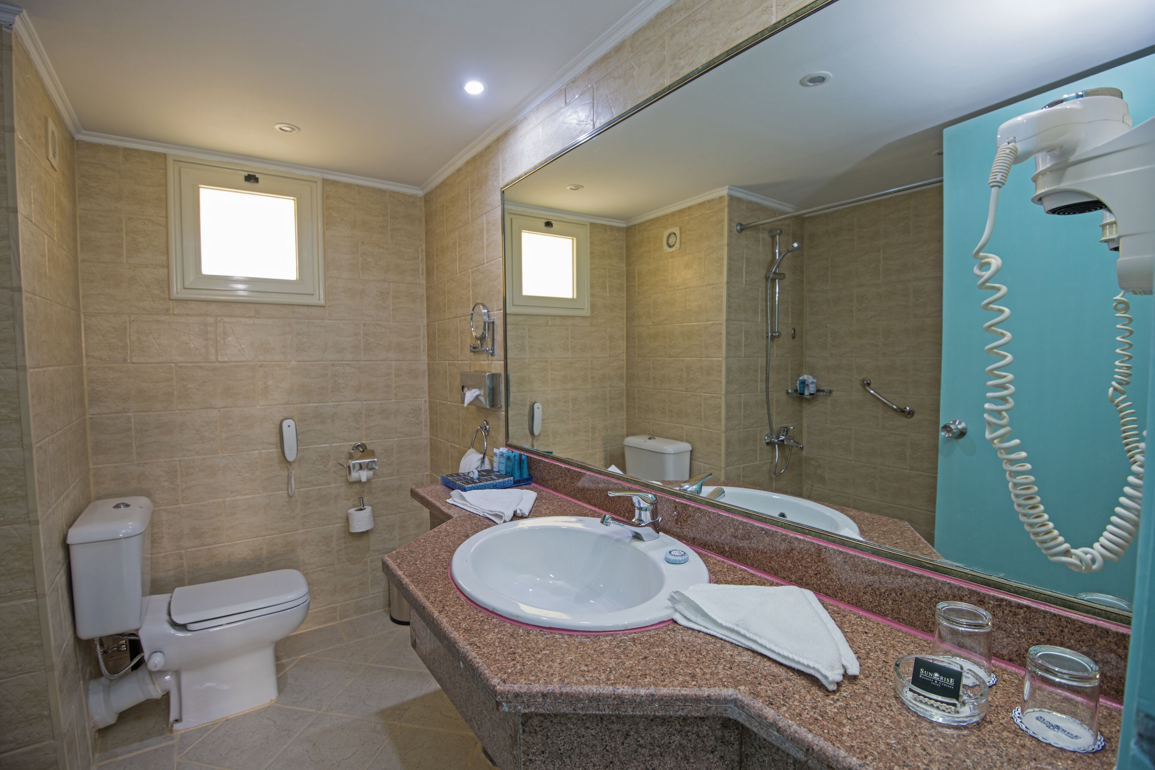 A bathroom with a sink, toilet, and shower.
