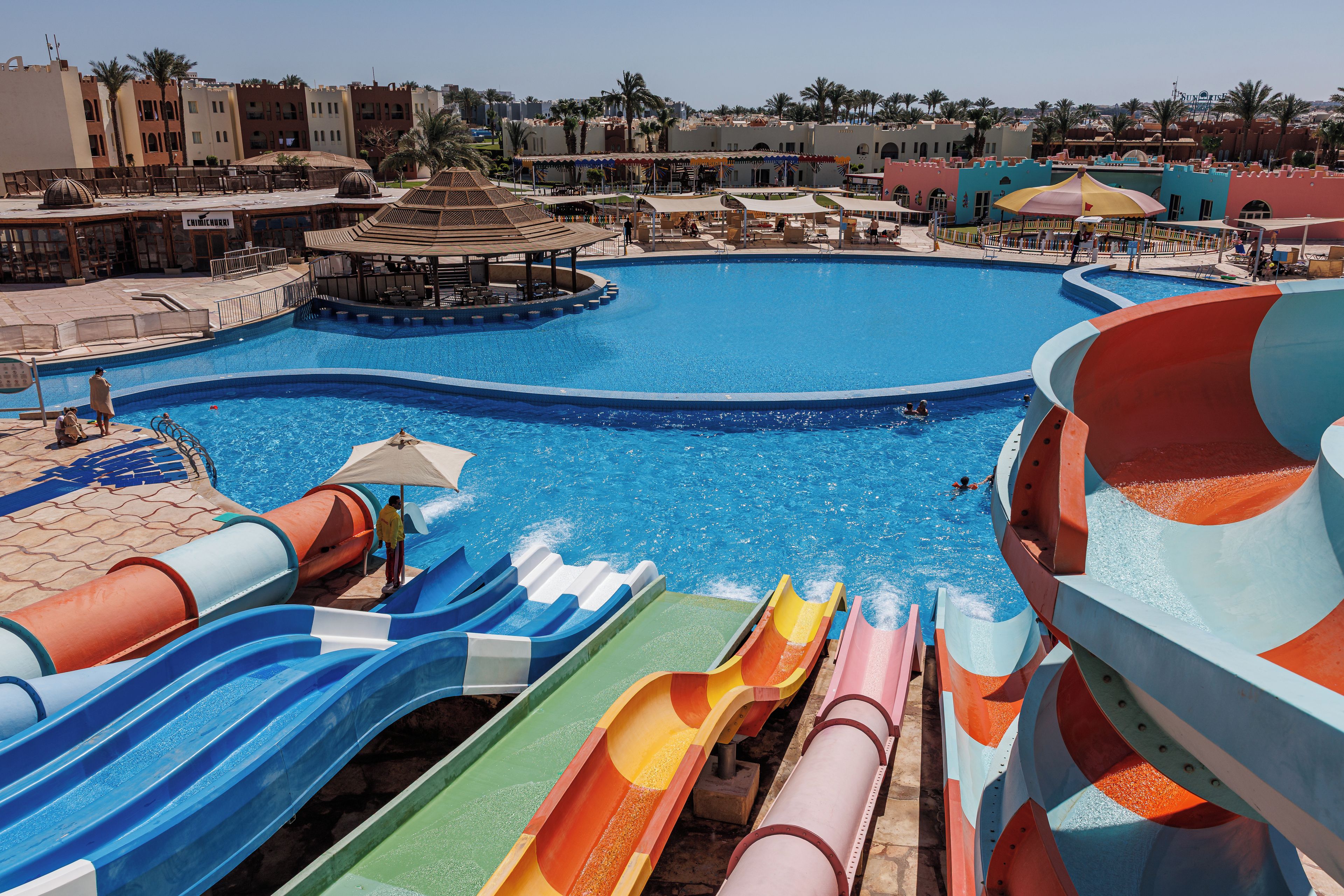 A water park with multiple slides and a large pool.