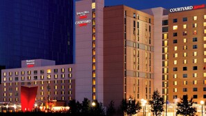 A multi-story hotel with signage for 'SpringHill Suites' and 'Courtyard' indicating different sections. - SpringHill Suites by Marriott Indianapolis Downtown (Indianapolis)
