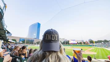A stadium with a clear view of the field and a large screen displaying the game.